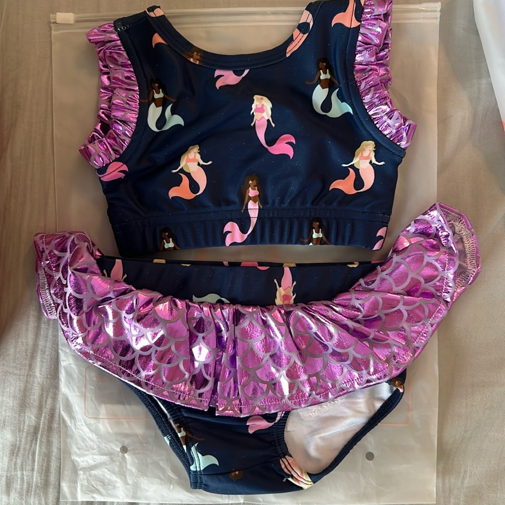Smocked sweets, two piece mermaid bathing suit 12 months. New in bag.